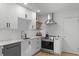 Modern white kitchen with stainless steel appliances, subway tile backsplash, and sleek countertops at 1368 Little David Court Ct, Charleston, SC 29412