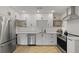 Modern white kitchen featuring stainless steel appliances, subway tile backsplash, and sleek countertops at 1368 Little David Court Ct, Charleston, SC 29412