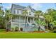 Charming two-story home with a wrap around porch, staircase entry, and lush, green landscaped yard at 1447 Headquarters Plantation Dr, Johns Island, SC 29455