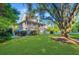 Beautiful two-story home with well-kept lawn, lush greenery, and a partially visible pool at 1447 Headquarters Plantation Dr, Johns Island, SC 29455