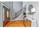 Elegant foyer showcasing hardwood floors, a staircase, and decorative mirror and lamps at 1447 Headquarters Plantation Dr, Johns Island, SC 29455