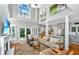 Bright and airy living room featuring a fireplace, large windows, and seamless flow to the kitchen at 1447 Headquarters Plantation Dr, Johns Island, SC 29455