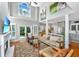 Bright and airy living room featuring a fireplace, large windows, and seamless flow to the kitchen at 1447 Headquarters Plantation Dr, Johns Island, SC 29455