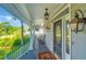 Inviting covered porch with rocking chairs, a patterned rug, and decorative outdoor lighting at 1447 Headquarters Plantation Dr, Johns Island, SC 29455