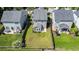 Aerial view of a home with a well-maintained lawn, wood fence and back sunroom at 1484 Milldam Pass, Johns Island, SC 29455