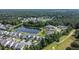 Scenic aerial view of a residential community surrounding a tranquil lake, nestled within lush green trees and landscaping at 1484 Milldam Pass, Johns Island, SC 29455