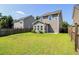 This backyard features a well-maintained lawn, wood fence and a sunroom at 1484 Milldam Pass, Johns Island, SC 29455