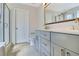 Modern bathroom with double sink, gray cabinets and a glass enclosed shower at 1484 Milldam Pass, Johns Island, SC 29455