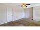 This carpeted bedroom offers a neutral palette, ceiling fan and has easy access to two closets at 1484 Milldam Pass, Johns Island, SC 29455