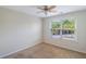 Bright bedroom with a ceiling fan, tan carpet and large window with natural light at 1484 Milldam Pass, Johns Island, SC 29455