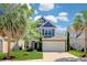 Charming two-story home with a well-manicured lawn, a two-car garage, and mature palm trees at 1484 Milldam Pass, Johns Island, SC 29455