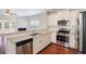 Modern kitchen features stainless steel appliances, white cabinets, and a seamless view into the bright living area at 1484 Milldam Pass, Johns Island, SC 29455