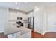 Modern kitchen boasts stainless steel appliances, white cabinetry, and a breakfast bar overlooking the dining area at 1484 Milldam Pass, Johns Island, SC 29455