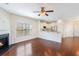Spacious living area with hardwood floors, a fireplace, and seamless flow into the modern kitchen at 1484 Milldam Pass, Johns Island, SC 29455