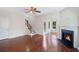 Bright living room featuring hardwood floors, a cozy fireplace, and a staircase leading to the second floor at 1484 Milldam Pass, Johns Island, SC 29455