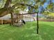 Large backyard with lush grass, mature trees, swing set and privacy fence at 1491 Greenshade Way, Mount Pleasant, SC 29464