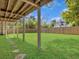 Spacious backyard featuring lush green grass, mature trees and a privacy fence at 1491 Greenshade Way, Mount Pleasant, SC 29464