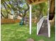 Well-maintained backyard featuring a playground, lush grass, and a privacy fence at 1491 Greenshade Way, Mount Pleasant, SC 29464