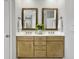 Bright bathroom with double sink vanity, wood framed mirrors, and stylish decor creating a serene atmosphere at 1491 Greenshade Way, Mount Pleasant, SC 29464