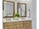 Bright bathroom with double sink vanity, wood framed mirrors, and stylish decor creating a serene atmosphere at 1491 Greenshade Way, Mount Pleasant, SC 29464