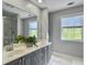 Bright bathroom with a double sink vanity, large mirror, and walk-in shower creating a luxurious feel at 1491 Greenshade Way, Mount Pleasant, SC 29464