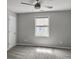 Cozy bedroom with soft carpeting, a ceiling fan, and a window offering natural light and a peaceful ambiance at 1491 Greenshade Way, Mount Pleasant, SC 29464
