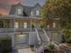 Inviting home with a double-decker porch, stairs, and two garage doors at 1491 Greenshade Way, Mount Pleasant, SC 29464
