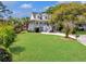Lush front yard with healthy green grass and a charming white home with a welcoming porch at 1491 Greenshade Way, Mount Pleasant, SC 29464