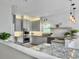Bright kitchen features gray cabinets, granite countertops, stainless steel appliances, and modern pendant lighting at 1491 Greenshade Way, Mount Pleasant, SC 29464
