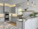 Bright kitchen features gray cabinets, granite countertops, stainless steel appliances, and modern pendant lighting at 1491 Greenshade Way, Mount Pleasant, SC 29464
