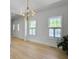 Large living room with wood floors and two windows, with lots of natural light at 1491 Greenshade Way, Mount Pleasant, SC 29464