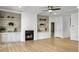 Bright and spacious living room featuring hardwood floors and a fireplace with shelving at 1491 Greenshade Way, Mount Pleasant, SC 29464