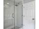Modern bathroom with frameless glass shower, rain shower head and gray tile at 1491 Greenshade Way, Mount Pleasant, SC 29464