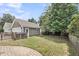 Backyard features a detached garage, grassy lawn and a brick patio at 1523 Nautical Chart Dr, Charleston, SC 29414