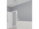 Light gray bedroom with partial view of lower trim, door, and empty carpeted room at 1523 Nautical Chart Dr, Charleston, SC 29414