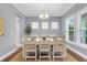 Dining room with a white wooden table, six chairs, and bright natural light at 1523 Nautical Chart Dr, Charleston, SC 29414