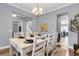 A stylish dining room with a white wooden table and six chairs under an elegant chandelier at 1523 Nautical Chart Dr, Charleston, SC 29414
