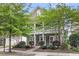 Charming two-story home featuring a spacious front porch and beautifully landscaped front yard with mature trees at 1523 Nautical Chart Dr, Charleston, SC 29414