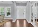 Bright foyer features hardwood floors, a white front door with sidelights, and beautiful french doors at 1523 Nautical Chart Dr, Charleston, SC 29414