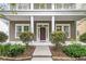 Inviting front porch featuring classic columns, manicured bushes, and an elegant entrance with a red door at 1523 Nautical Chart Dr, Charleston, SC 29414