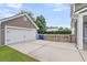 Detached garage with a concrete driveway and white door at 1523 Nautical Chart Dr, Charleston, SC 29414