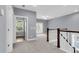 Hallway landing featuring stairs, a door to a room with a window, and a door to a room with French doors at 1523 Nautical Chart Dr, Charleston, SC 29414