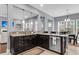 Modern kitchen with dark cabinets, granite countertops, stainless steel appliances, and an open view to living and dining area at 1523 Nautical Chart Dr, Charleston, SC 29414