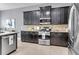 A well-lit kitchen featuring dark wood cabinets, granite countertops, and stainless steel appliances at 1523 Nautical Chart Dr, Charleston, SC 29414