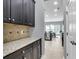 Bright kitchen with dark cabinets, granite countertops, and an eat-in area with lots of natural light at 1523 Nautical Chart Dr, Charleston, SC 29414