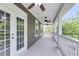 Spacious porch with white railing, white doors and ceiling fans at 1523 Nautical Chart Dr, Charleston, SC 29414