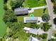 Aerial view of a quaint coastal home, surrounded by lush greenery, neatly maintained lawn and a long driveway at 1625 Teal Marsh Rd, Charleston, SC 29412