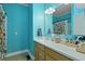 Bathroom with bright blue walls, a shower with colorful curtains, and a spacious counter at 1625 Teal Marsh Rd, Charleston, SC 29412