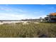 Beautiful beach with ocean views, a pier, and umbrellas at 1625 Teal Marsh Rd, Charleston, SC 29412