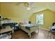 This bedroom has yellow walls, a white ceiling fan, and a white bed frame with a bed inside at 1625 Teal Marsh Rd, Charleston, SC 29412